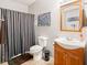 Bathroom featuring a vanity, toilet, shower with striped curtain, and tiled floor at 13861 Barberry Ct, Carmel, IN 46033