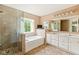 Luxurious bathroom featuring a glass-enclosed shower, soaking tub, and double vanity sinks at 13861 Barberry Ct, Carmel, IN 46033