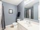 Well-lit bathroom with a neutral color scheme, featuring a shower with a patterned curtain at 13861 Barberry Ct, Carmel, IN 46033