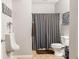 Bathroom featuring a toilet, urinal, shower with striped curtain, and tiled floor at 13861 Barberry Ct, Carmel, IN 46033