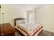 Cozy bedroom with a wooden bed frame and a colorful patchwork quilt on the bed at 13861 Barberry Ct, Carmel, IN 46033