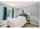 Comfortable bedroom with a large window, plush carpeting, and stylish decor elements at 13861 Barberry Ct, Carmel, IN 46033