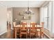 Cozy dining room featuring a wooden table, chandelier, and natural light, perfect for Gathering meals at 13861 Barberry Ct, Carmel, IN 46033