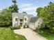 Beautiful two-story home featuring a brick facade, attached garage, and well-manicured landscaping on a sunny day at 13861 Barberry Ct, Carmel, IN 46033