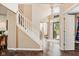 Elegant foyer with a staircase, hardwood floors, high ceilings, and natural light streaming through the front door at 13861 Barberry Ct, Carmel, IN 46033