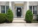 Charming front entrance with a welcoming door, stylish sidelights, and neatly trimmed evergreens at 13861 Barberry Ct, Carmel, IN 46033