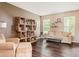 Comfortable living room with a sofa, chair, bookshelf, and natural light, creating a cozy atmosphere at 13861 Barberry Ct, Carmel, IN 46033