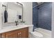 Stylish bathroom featuring blue tiled shower, sleek fixtures, and a modern wood vanity at 1405 Deloss St, Indianapolis, IN 46201