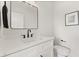 Bright bathroom features a modern vanity, black hardware, and a sleek, white toilet at 1405 Deloss St, Indianapolis, IN 46201