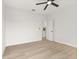 A clean white bedroom with light colored floors and a simple ceiling fan at 1405 Deloss St, Indianapolis, IN 46201