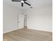 Spacious bedroom with light wood flooring, a ceiling fan, and white walls at 1405 Deloss St, Indianapolis, IN 46201