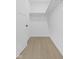 Walk-in closet with white walls, shelving, and light wood floors at 1405 Deloss St, Indianapolis, IN 46201