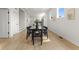 Contemporary dining area leading to kitchen, featuring minimalist decor, modern black table and chairs, and light-filled space at 1405 Deloss St, Indianapolis, IN 46201