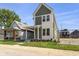 Charming two-story home with fresh landscaping and a welcoming front porch at 1405 Deloss St, Indianapolis, IN 46201