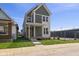 Charming two-story home featuring a welcoming porch, a well-manicured lawn, and fresh flowers at 1405 Deloss St, Indianapolis, IN 46201