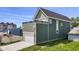Two-story home featuring a rear balcony and an attached garage with a driveway at 1405 Deloss St, Indianapolis, IN 46201