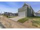 View of the exterior of the detached garage that features a deck above and a long driveway at 1405 Deloss St, Indianapolis, IN 46201