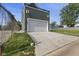 Angled exterior shot of the garage that features a deck, new concrete driveway and a white door at 1405 Deloss St, Indianapolis, IN 46201