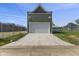 Exterior front of the detached garage with a new concrete driveway and deck atop the structure at 1405 Deloss St, Indianapolis, IN 46201
