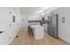 Well-lit kitchen featuring white cabinets, a center island with seating, and stainless steel appliances for a sleek and modern look at 1405 Deloss St, Indianapolis, IN 46201