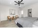 Inviting main bedroom with chairs, stylish decor, ceiling fan and ensuite bathroom at 1405 Deloss St, Indianapolis, IN 46201