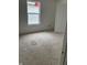An unfinished bedroom with bright walls, a window, and an open door at 1441 Elm St, Martinsville, IN 46151