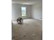 Spacious unfinished bedroom with a large window offering natural light and scenic views at 1441 Elm St, Martinsville, IN 46151