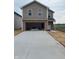 Two-story home featuring a brick and vinyl exterior, a spacious two-car garage, and a concrete driveway at 1441 Elm St, Martinsville, IN 46151