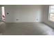 Bright room featuring white walls, a window, and a plastic-covered floor at 1441 Elm St, Martinsville, IN 46151