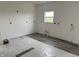Room with new flooring being installed on top of plastic-covered floors and bright walls at 1441 Elm St, Martinsville, IN 46151