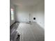 Room with new flooring being installed, plastic-covered floors, and bright walls at 1441 Elm St, Martinsville, IN 46151