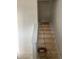 Staircase featuring unfinished wood stairs, a white banister, and white walls at 1441 Elm St, Martinsville, IN 46151