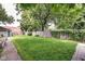 Large, grassy backyard enclosed by a wooden fence and mature trees at 1548 N Park Ave, Indianapolis, IN 46202