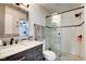 Modern bathroom features a glass-enclosed shower with subway tile and updated vanity at 1548 N Park Ave, Indianapolis, IN 46202