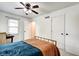 Bright bedroom features hardwood floors, a ceiling fan, and neutral decor at 1548 N Park Ave, Indianapolis, IN 46202