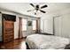 Bright bedroom features hardwood floors, a ceiling fan, and neutral decor at 1548 N Park Ave, Indianapolis, IN 46202