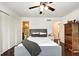 Bedroom with ensuite bathroom, hardwood floors, ceiling fan, and closet at 1548 N Park Ave, Indianapolis, IN 46202