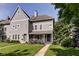 Charming two-story home with a well-manicured lawn, inviting front porch, and beautiful landscaping at 1548 N Park Ave, Indianapolis, IN 46202