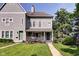Beautiful two-story home with well-maintained lawn, inviting porch with flowers, and classic architectural details at 1548 N Park Ave, Indianapolis, IN 46202