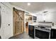 A view of the corner of a kitchen and a rustic wooden barn door leading to another room at 1548 N Park Ave, Indianapolis, IN 46202