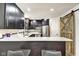 Modern kitchen features black cabinets, subway tile backsplash, and a breakfast bar with seating at 1548 N Park Ave, Indianapolis, IN 46202