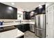Updated kitchen with sleek black cabinetry, stainless steel appliances, and modern tile flooring at 1548 N Park Ave, Indianapolis, IN 46202