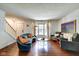 Open-concept living room with staircase, hardwood floors, and plenty of natural light at 1548 N Park Ave, Indianapolis, IN 46202