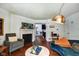 Open-concept living room with fireplace, hardwood floors, and view into the kitchen at 1548 N Park Ave, Indianapolis, IN 46202