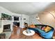 Cozy living room with fireplace, stylish seating, and a partial view into the kitchen at 1548 N Park Ave, Indianapolis, IN 46202