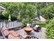 A backyard patio with a fire pit, outdoor seating, string lights, and lush greenery. Perfect for entertaining and relaxing at 1548 N Park Ave, Indianapolis, IN 46202