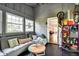 Inviting sunroom with gray wood paneling, comfortable seating, and plenty of natural light at 1548 N Park Ave, Indianapolis, IN 46202