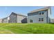 A view of the backyard featuring the grassy lawn and the exterior of neighboring homes at 1669 Windrush Pl, Westfield, IN 46074