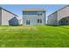 View of the backyard featuring a large green lawn and a house with light blue siding at 1669 Windrush Pl, Westfield, IN 46074