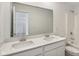 Bright bathroom featuring a double vanity, white cabinetry, and a large mirror at 1669 Windrush Pl, Westfield, IN 46074
